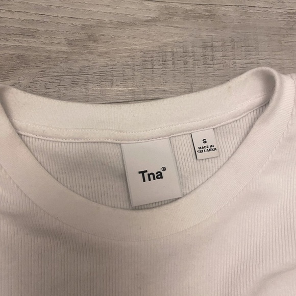 This a white long sleeve, TNA shirt that is still in the stores to this day - Picture 3 of 5